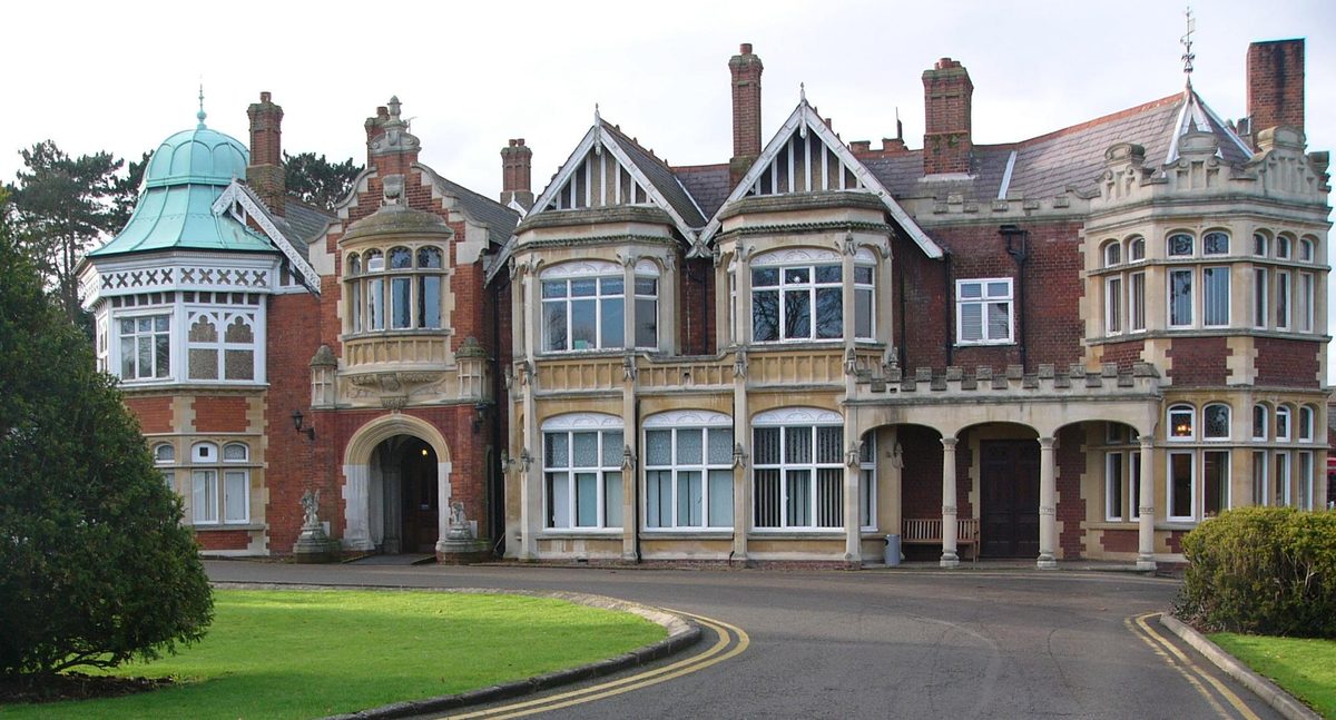 The red-brick Victorian mansion at Bletchley Park in England under a pale sky
